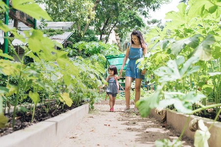Happy Asian daughter gardening with her motherの写真素材