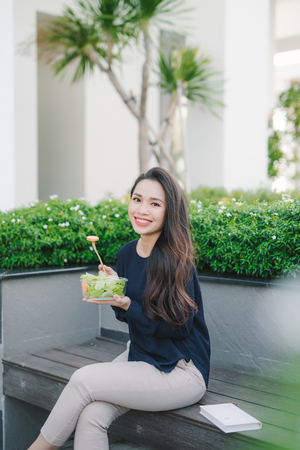 Beautiful healthy woman eating saladの写真素材