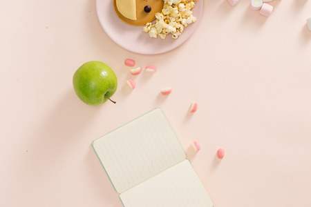 Baby pancakes for breakfast. Creative idea for the kid dessert: delicious pancakes in the form of the happy face with the hair making popcornの写真素材