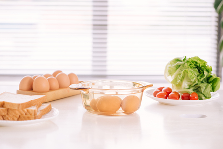 Healthy breakfast consisting of toast, eggs, salad, tomatoの写真素材