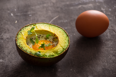 Homemade Organic Egg Baked in Avocado with Salt and Pepperの写真素材
