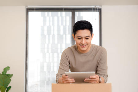 Happy man organize relocation in his new apartment