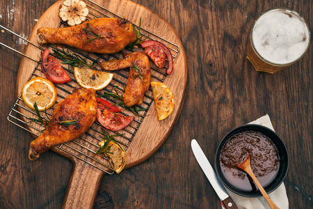 Hot and spicy chicken drumstick and wings closeup with beerの写真素材