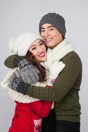 Happy young hipster couple hugging. Cold season. Romantic mood.の写真素材