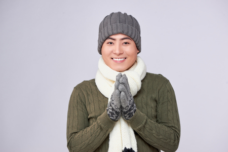 Handsome winter asian man in knitted woolen clothing hatの写真素材