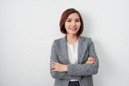 Entrepreneur young asian woman, business woman arms crossed on white background.の写真素材
