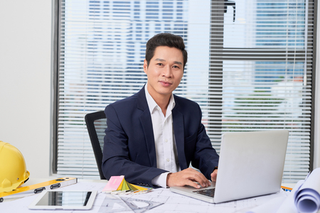 Male designer in office working on architects projectの写真素材