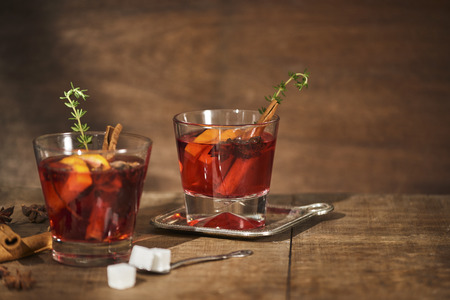 Autumnal concept with cup of tea with lemon, cinnamon stick and anise star on rustic wooden backgroundの写真素材