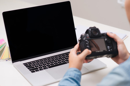 Photographer working at desk in modern office