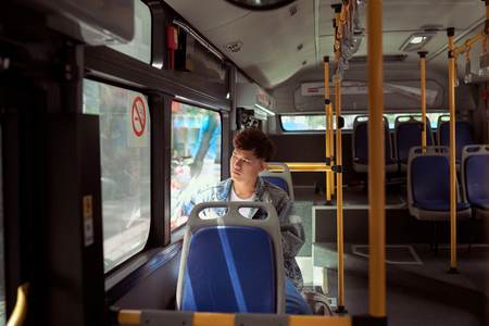passenger traveler looking at window in bus, man tourist sitting in busの写真素材
