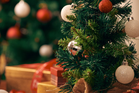 Decorating Christmas tree on bright backgroundの写真素材