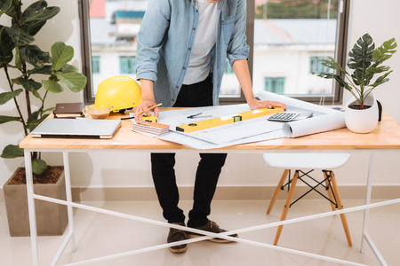Workplace items tools for project, Architect or Engineer working on blueprint for architectural project in progress, construction and structure concept.の写真素材