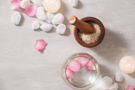 Spa settings with roses. Spa theme with candles and flowers on table.の写真素材