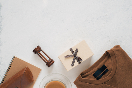 Still life, fashion, business, father's day concept. T-Shirt and frame for father day's greeting on white background. Selective focus, top view, copy space backgroundの写真素材