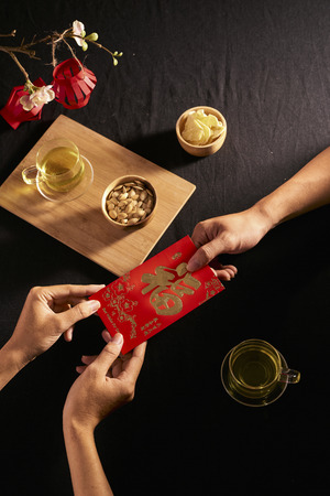 Chinese Lunar New Year concept red envelope with Chinese character means happiness or good fortune, the chinese sentence means âWishing you prosperityâ and âMay all your wishes come trueâ.の写真素材