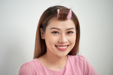 beautiful girl with curlers on her head, a large portraitの写真素材