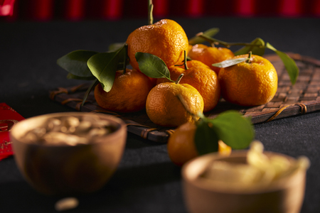 Lunar new year food and drink still life on black background. Translation of text appear in image: Prosperity.の写真素材