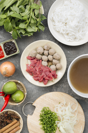 Traditional vietnamese noodle soups pho in bowls, concrete background. Vietnamese beef soup pho bo,...