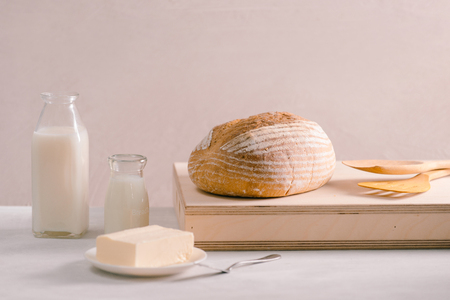 Bread bake and butter on wooden cutting board. Simple breakfastの写真素材