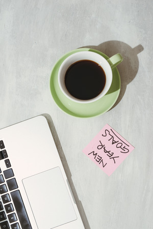 cropped image of woman holding paper sticker with word ideas near laptopの写真素材
