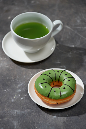 Matcha and white chocolate donuts with matcha tea latteの写真素材