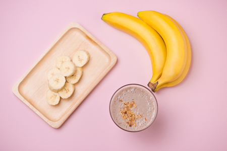 Banana Smoothie on a yellow background. Selective focusの写真素材