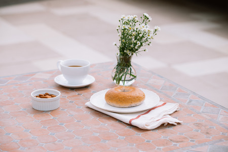 cup of coffee with bread on table in the morning with sunlight, breakfast