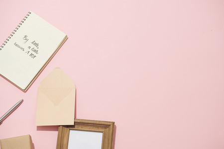 open notebook with blank pages on pink background with beautiful bouquet of roses
