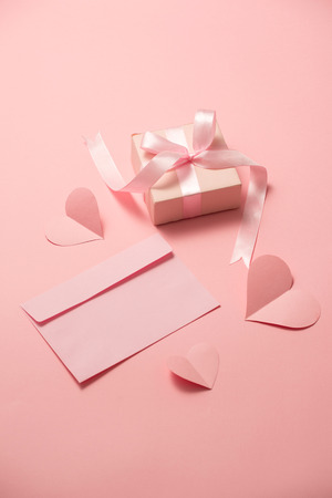 Woman's Day; romantic template; mock up with heart paper; pink box gift; bow ribbon and envelope in pink backgroundの写真素材