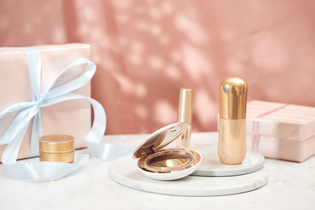 Gift box decorated with ribbon filled with cosmeticsの写真素材