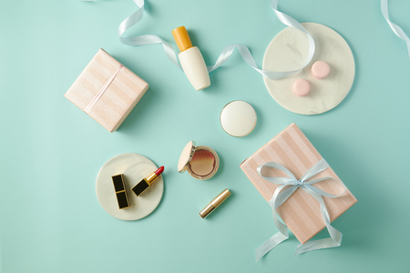Make up table with foundation, blush, brushes, lipstick and giftbox indoorsの写真素材
