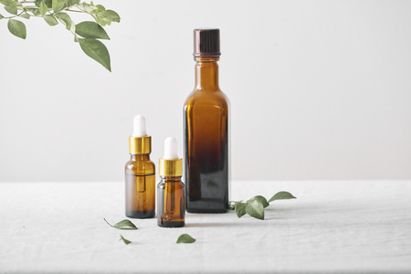 Bottles with aroma oil, medicines on wooden background. Selective focus,horizontal.の写真素材