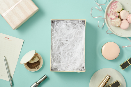 image of make up products with gift box on blue backgroundの写真素材