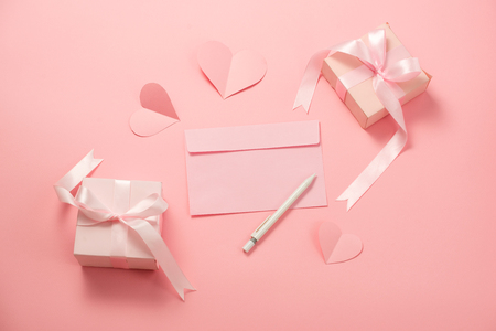 Woman's Day; romantic template; mock up with heart paper; pink box gift; bow ribbon and envelope in pink backgroundの写真素材