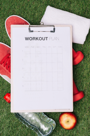 Sheet of paper and sports equipment on grass close-upの写真素材