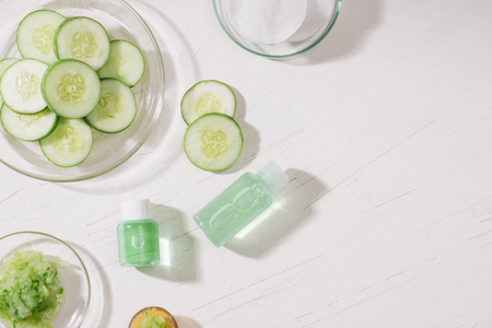 Cosmetic bottle and fresh organic cucumber for skincare. Home spa concept.の写真素材