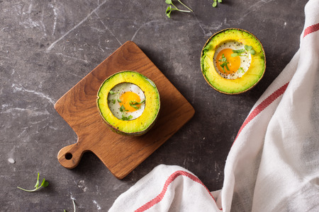 Homemade Organic Egg Baked in Avocado with Salt and Pepperの写真素材