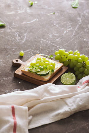 Perfect gourmet appetizer. Toast bread with green salads on top. Bread, vegetable and fruit. Diet concept.の写真素材