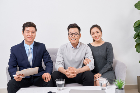 Real estate agent working with clients in officeの写真素材