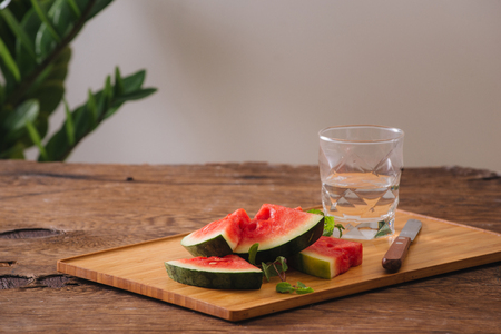 Sliced watermelon with pure water on the wood backgroudの写真素材