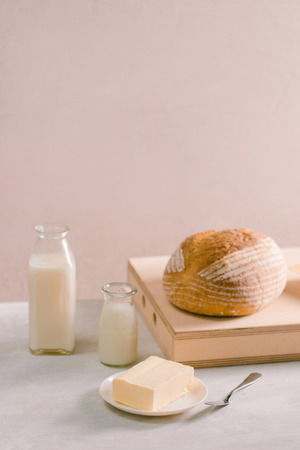 Bread bake and butter on wooden cutting board. Simple breakfastの写真素材