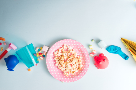 Holiday frame or background with colorful balloon, gift, confetti, silver star, carnival cap and streamer. Flat lay style. Birthday or party greeting card with copy space.の写真素材