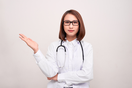 young doctor woman showing copy space isolated on white backgroundの写真素材