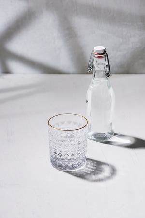 Glass bottle of water with drinking glassの写真素材