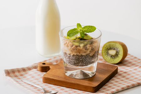 Healthy breakfast with yogurt, nut, kiwi and chia seeds. Bowl of fresh fruit.の写真素材