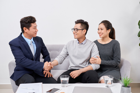 Real estate agent working with clients in officeの写真素材