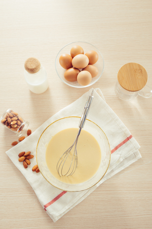 recipe ingredients : eggs, flour, milk, almonds, banana on white backgroundの写真素材