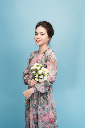 Lovely girl holds flowers bouquetの写真素材