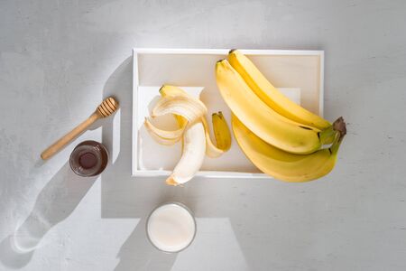 a sliced banana in a bowl on wooden backgroundの写真素材