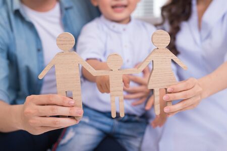 Happy asian family sitting on the sofa in the living room of their home together.の写真素材